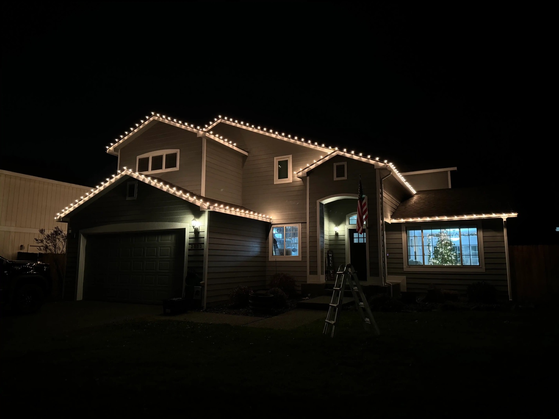 Two-story home with warm white C9 roofline lighting